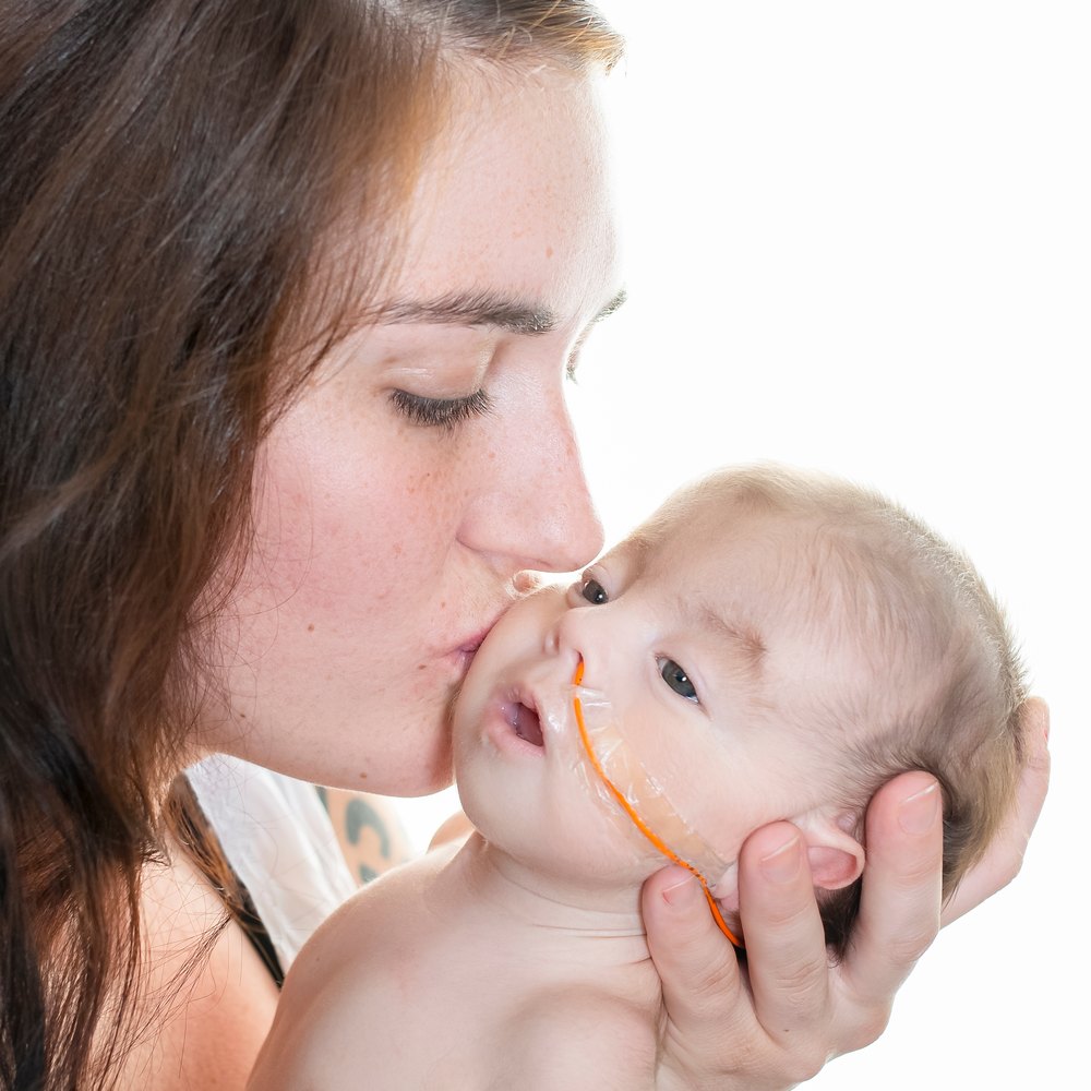 Pediatric nurse teaching a parent G-tube site care at home in Las Vegas