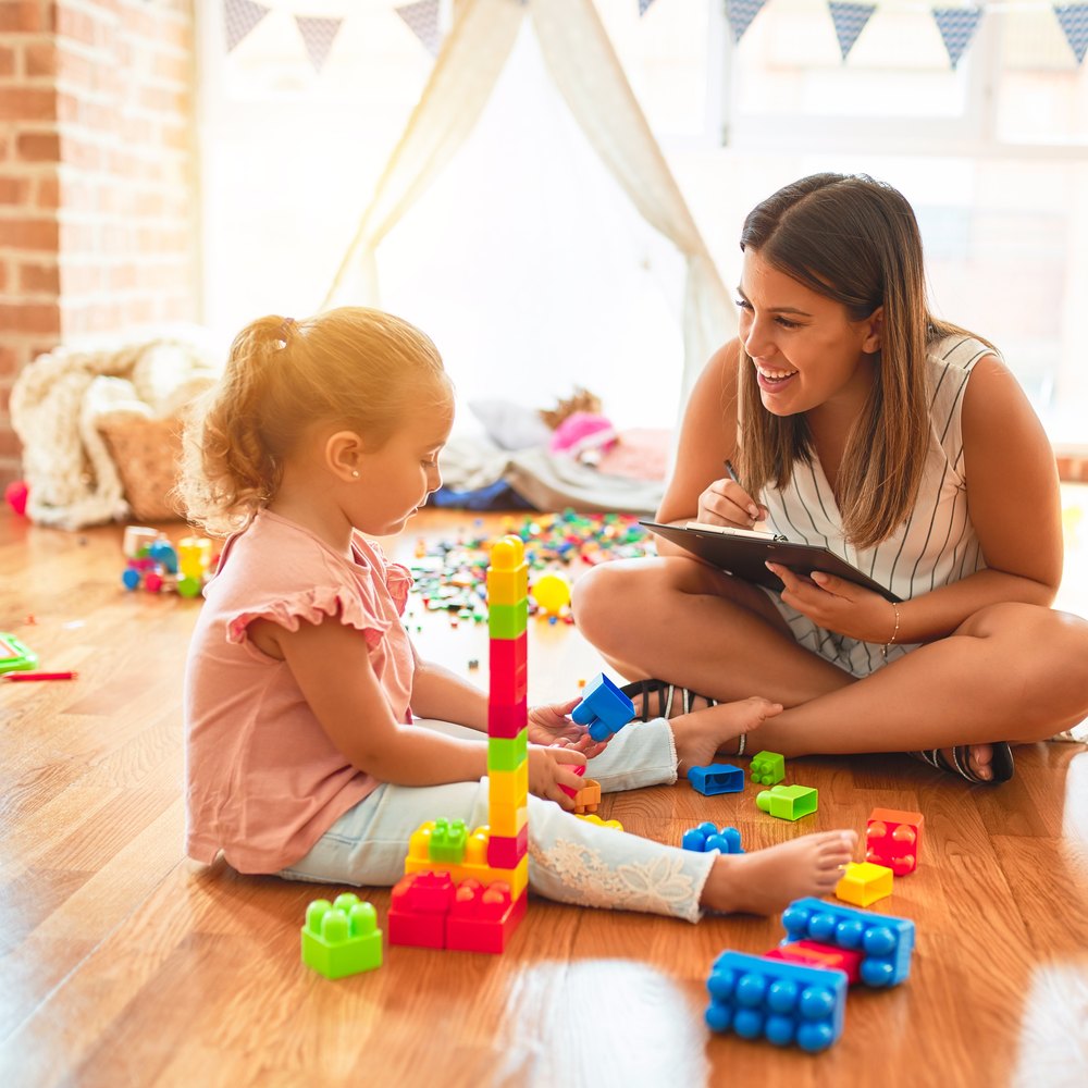 Pediatric therapist doing play-based therapy with a toddler at home in Henderson
